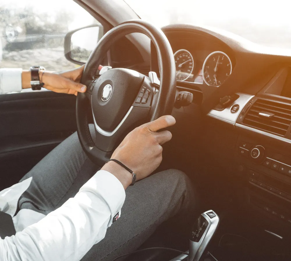 Driver with hands on steering wheel